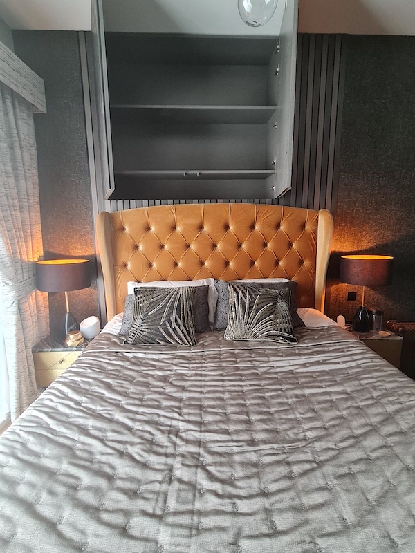 AG tower bedroom with weir niche, home styling in dubaiu, dubai home styling and decor, boutique hotel style dark bedroom with mustard bed, wall paneling