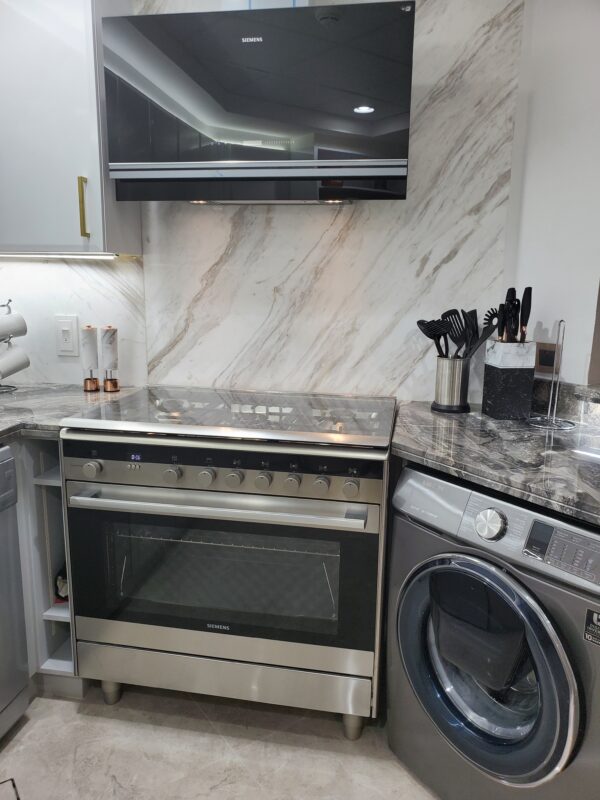 kitchen with window design, palm jumeirah kitchen window, kitchen design before and after, washing machine, cabinet upgrade, marble tiling, marble counter top, marble design, golden palm jumeirah